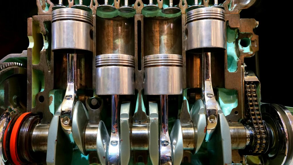 pexels-photo-190539-190539-1 Close-up image of car engine pistons and crankshaft, showcasing mechanical components.